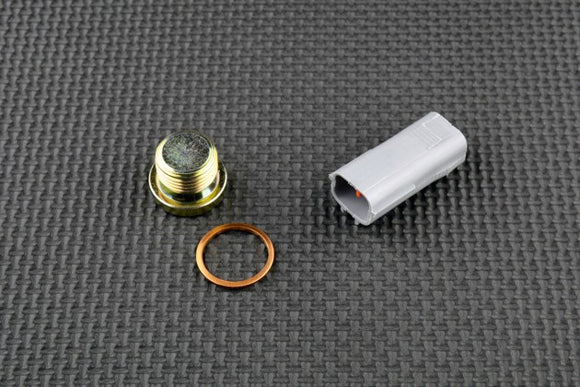 Yamaha FJR 1300 O2 sensor eliminator kit components: cap, connection, and copper washer on textured surface.